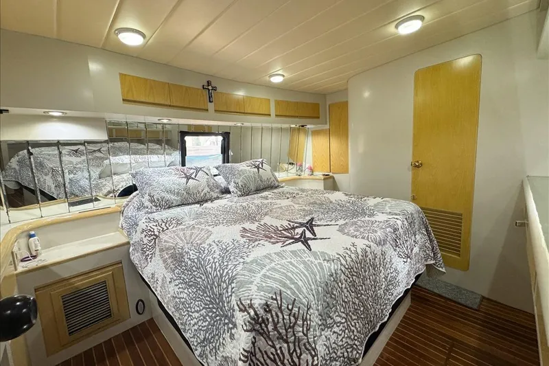 Slide: The Image of Cozy bedroom in 1994 President 445 Sundeck yacht with nautical-themed bedding. - 116