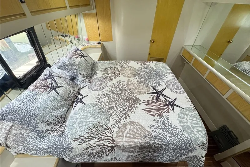 Slide: The Image of Cozy bedroom in 1994 President 445 Sundeck yacht with nautical-themed bedding. - 117