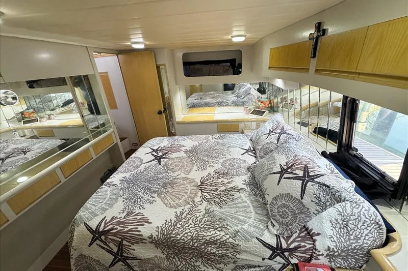 Slide: The Image of Cozy bedroom interior of 1994 President 445 Sundeck yacht with nautical-themed bedding. - 121