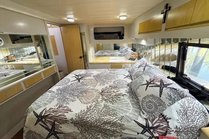 Slide: The Image of Cozy bedroom interior of 1994 President 445 Sundeck yacht with nautical-themed bedding. - 122