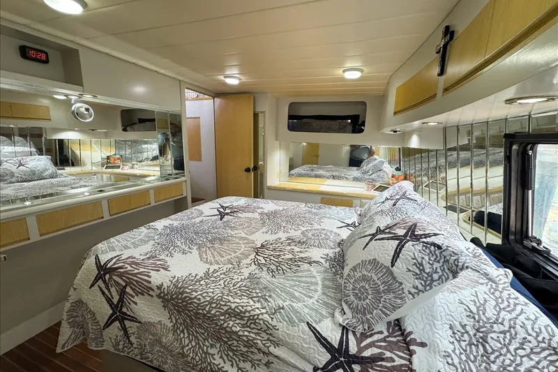 Slide: The Image of Luxurious bedroom interior of 1994 President 445 Sundeck yacht with elegant bedding and mirrors. - 124