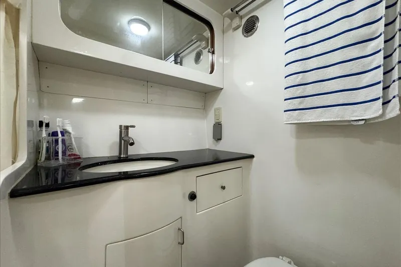 Slide: The Image of Bathroom interior of 1994 President 445 Sundeck yacht, featuring sink and striped towel. - 132