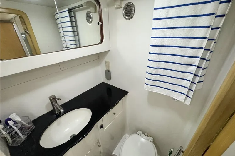 Slide: The Image of Bathroom interior of 1994 President 445 Sundeck yacht with sink and striped towel. - 134