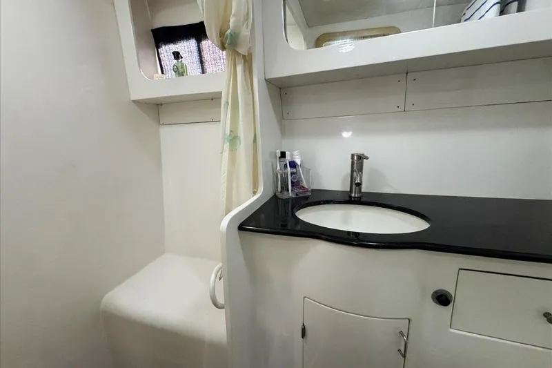Slide: The Image of 1994 President 445 Sundeck yacht bathroom with sink, mirror, and storage. - 137