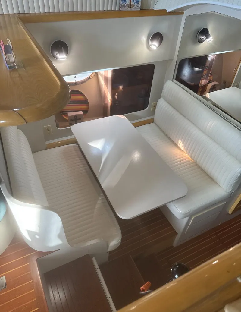 Slide: The Image of 1994 President 445 Sundeck yacht interior with chairs and stairs, featuring modern design elements. - 14