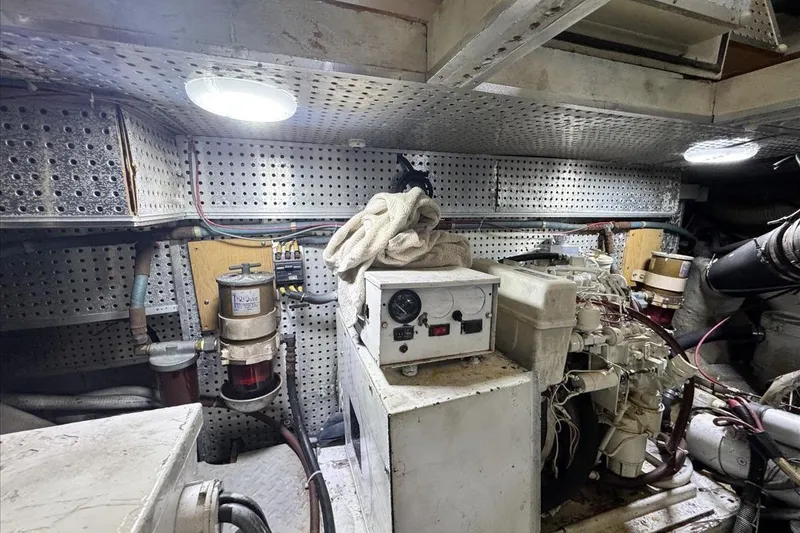 Slide: The Image of Engine room of a 1994 President 445 Sundeck yacht with machinery and equipment. - 142