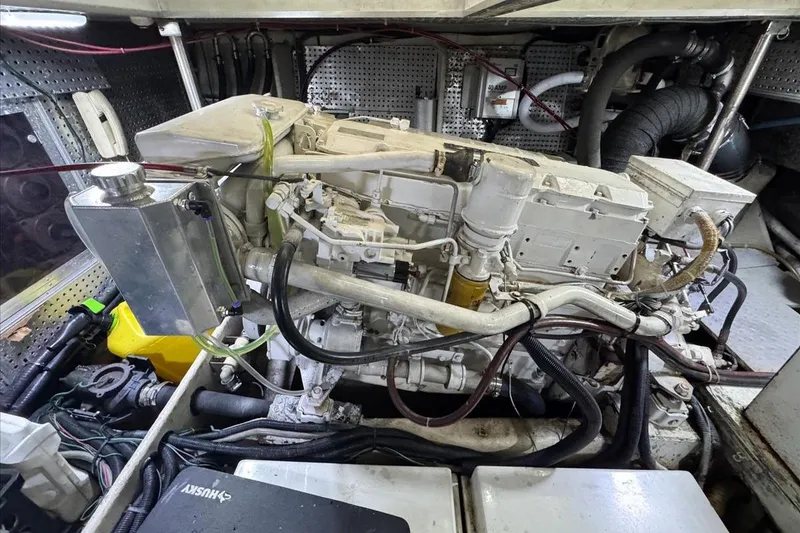 Slide: The Image of Engine room of a 1994 President 445 Sundeck yacht, showcasing mechanical components. - 143