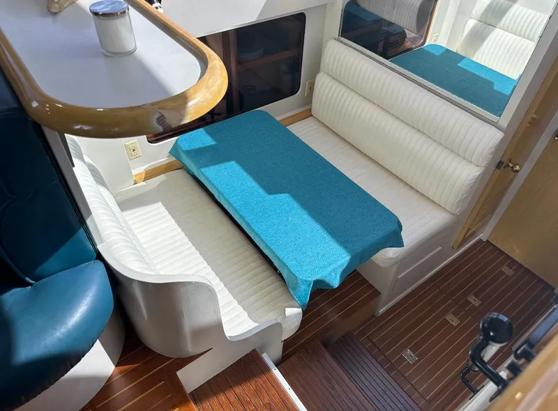 Slide: The Image of 1994 President 445 Sundeck yacht interior with seating and stairs, docked at marina. - 15