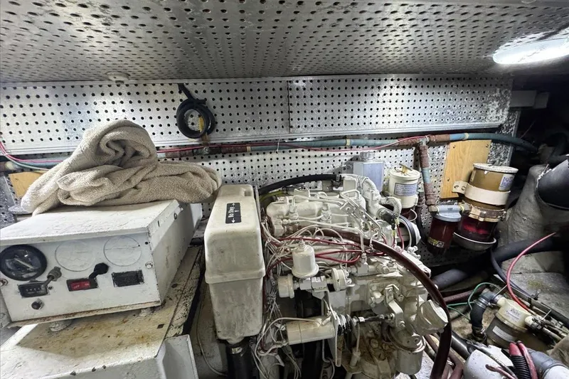 Slide: The Image of Engine room of 1994 President 445 Sundeck yacht with mechanical components and wiring. - 150