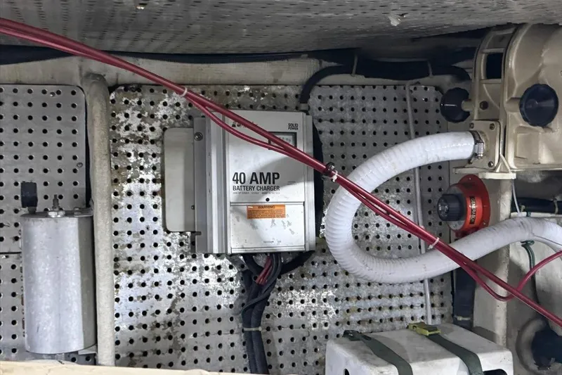 Slide: The Image of 1994 President 445 Sundeck engine room with 40 AMP battery charger and wiring. - 153