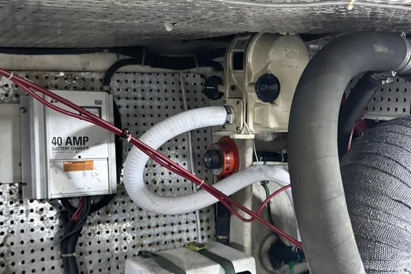 Slide: The Image of Engine room of 1994 President 445 Sundeck with battery charger and hoses. - 154