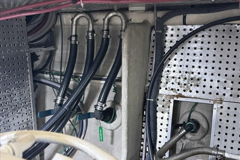 Slide: The Image of Engine room of 1994 President 445 Sundeck with hoses and metal fittings. - 155