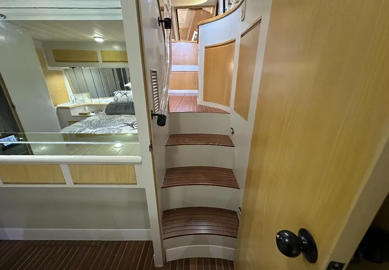 Slide: The Image of 1994 President 445 Sundeck yacht docked at marina with palm trees and clear sky. - 19