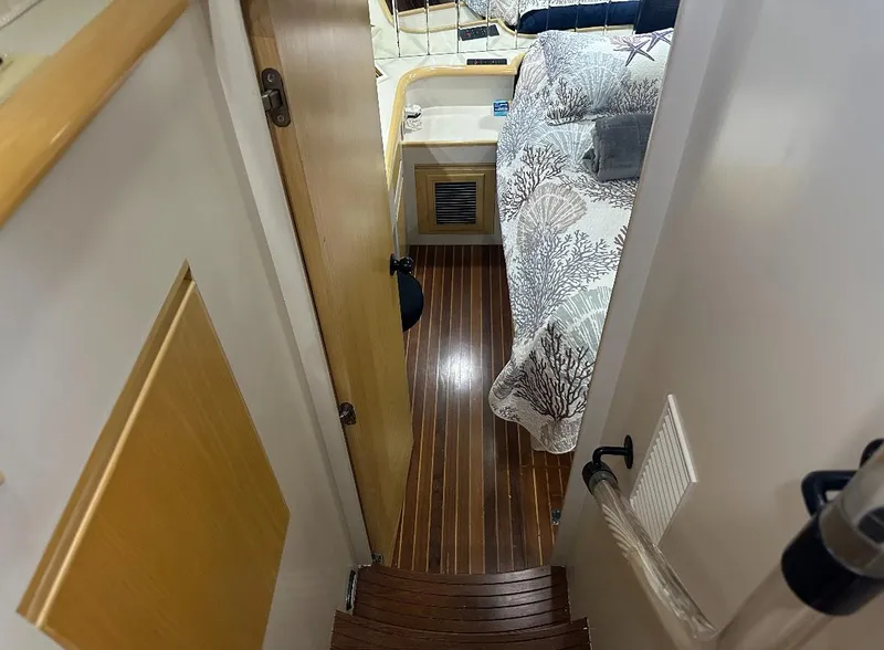 Slide: The Image of 1994 President 445 Sundeck boat helm with white seating and control panel. - 20