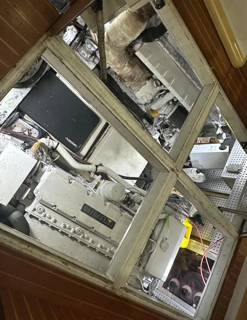 Slide: The Image of 1994 President 445 Sundeck boat dashboard with Garmin navigation system and communication devices. - 32