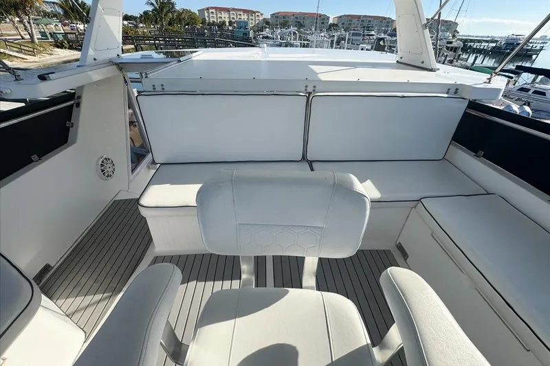 Slide: The Image of 1994 President 445 Sundeck yacht interior with white seating and marina view. - 35