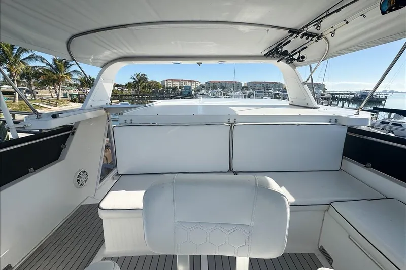 Slide: The Image of 1994 President 445 Sundeck yacht interior with white seating and marina view. - 36