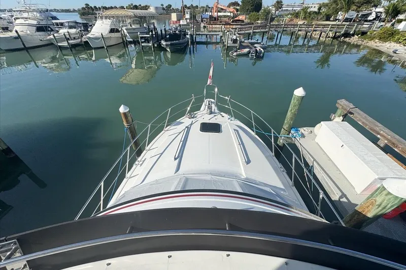 Slide: The Image of 1994 President 445 Sundeck yacht docked at a marina, viewed from above. - 44
