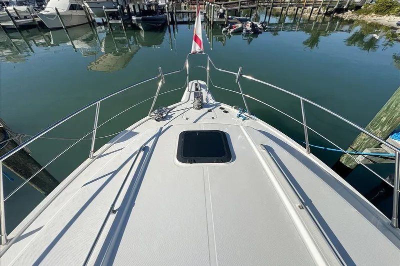 Slide: The Image of 1994 President 445 Sundeck yacht docked at marina, view from bow. - 49