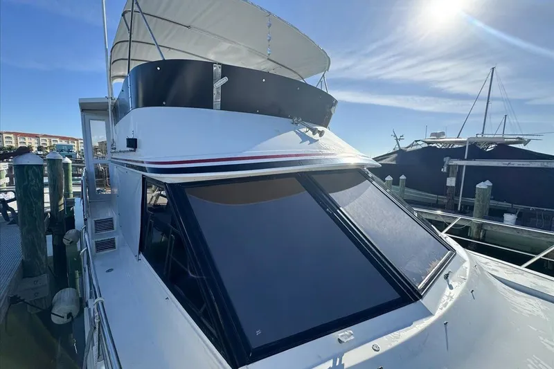 Slide: The Image of 1994 President 445 Sundeck yacht docked under sunny skies. - 55