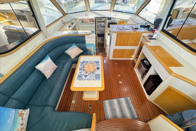 Slide: The Image of Interior of 1994 President 445 Sundeck yacht with elegant seating and wooden finishes. - 57