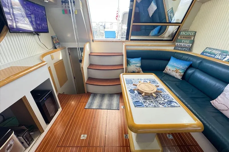 Slide: The Image of Luxurious interior of 1994 President 445 Sundeck yacht with cozy seating and nautical decor. - 61