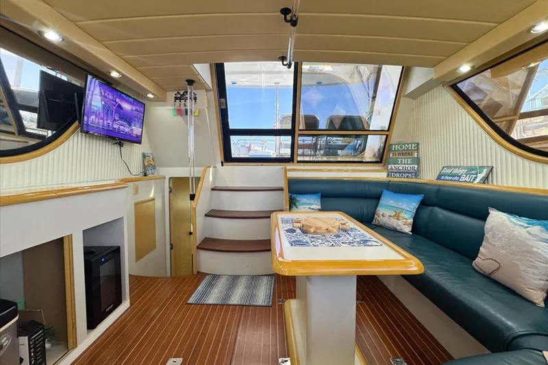 Slide: The Image of 1994 President 445 Sundeck yacht interior with cozy seating, TV, and nautical decor. - 63