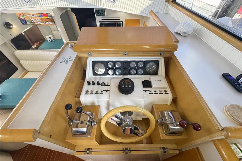 Slide: The Image of Interior helm of 1994 President 445 Sundeck yacht with wooden accents and control panel. - 66