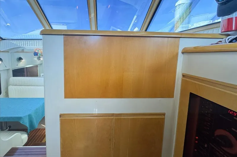 Slide: The Image of Interior of 1994 President 445 Sundeck yacht with wood paneling and blue accents. - 69