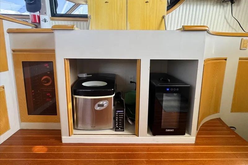 Slide: The Image of 1994 President 445 Sundeck interior with appliances and wooden cabinetry. - 73