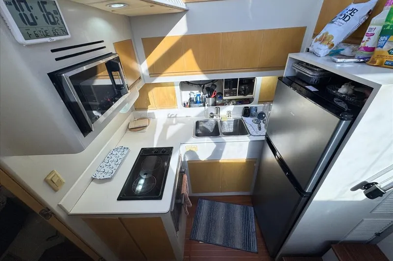 Slide: The Image of Compact kitchen in a 1994 President 445 Sundeck yacht with modern appliances. - 82