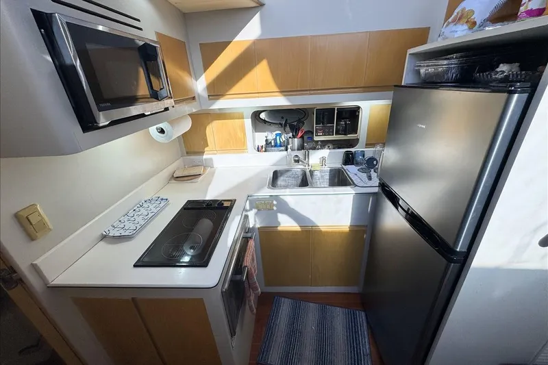 Slide: The Image of Compact kitchen in a 1994 President 445 Sundeck yacht with modern appliances. - 83