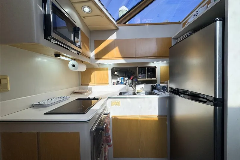 Slide: The Image of Modern kitchen interior on 1994 President 445 Sundeck yacht, featuring appliances and skylight. - 84