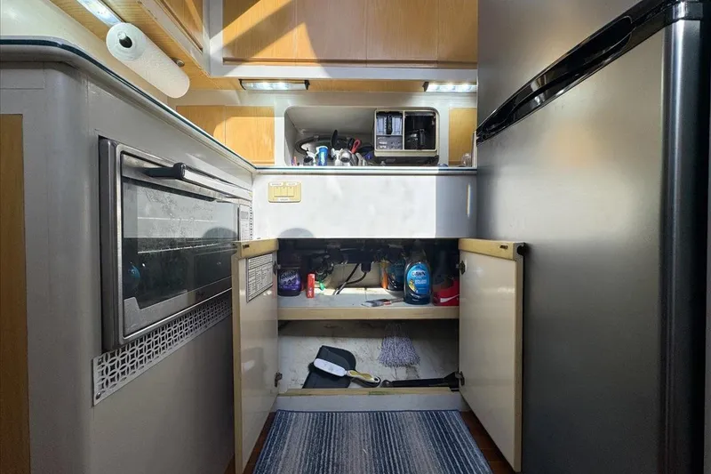 Slide: The Image of Compact kitchen area in a 1994 President 445 Sundeck yacht, featuring appliances and storage. - 86