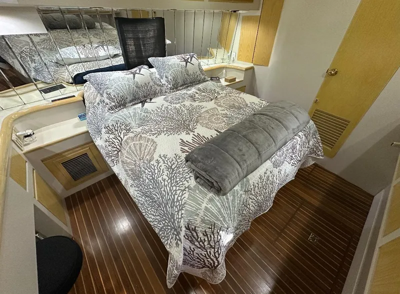 Slide: The Image of 1994 President 445 Sundeck yacht docked at marina with small boat attached. - 9