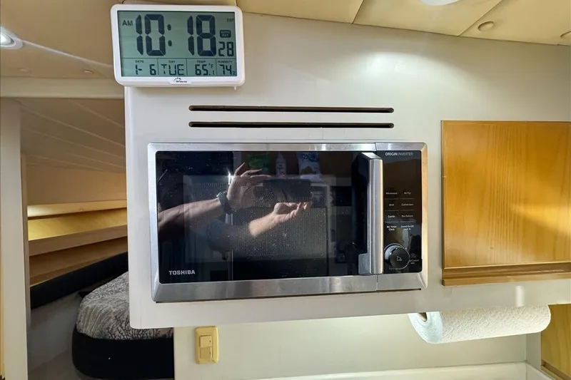 Slide: The Image of Microwave and clock in 1994 President 445 Sundeck yacht interior. - 90