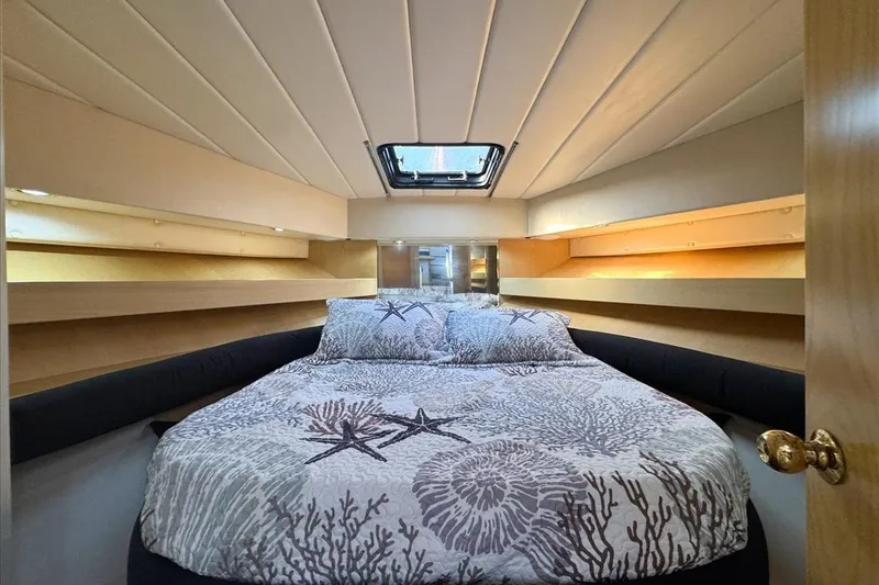 Slide: The Image of Cozy bedroom in 1994 President 445 Sundeck yacht with nautical-themed bedding. - 99