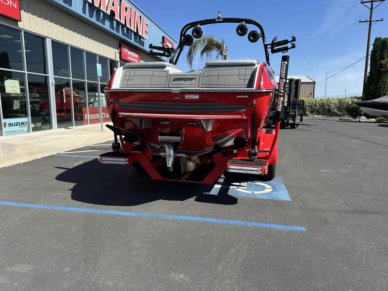 Slide: The Image of 2024 Sanger 231 SL boat in red, parked outside a marine dealership. - 4