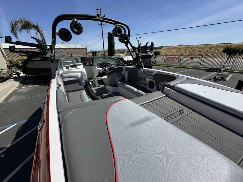 Slide: The Image of 2024 Sanger 231 SL boat interior with sleek seating and advanced audio system. - 6