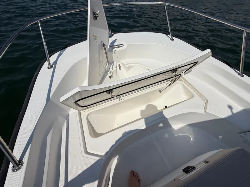 Slide: The Image of 2022 Boston Whaler 170 Montauk boat with open storage compartment on deck. - 10