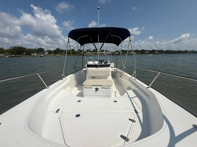 Slide: The Image of 2022 Boston Whaler 170 Montauk boat on calm water under a blue sky. - 12