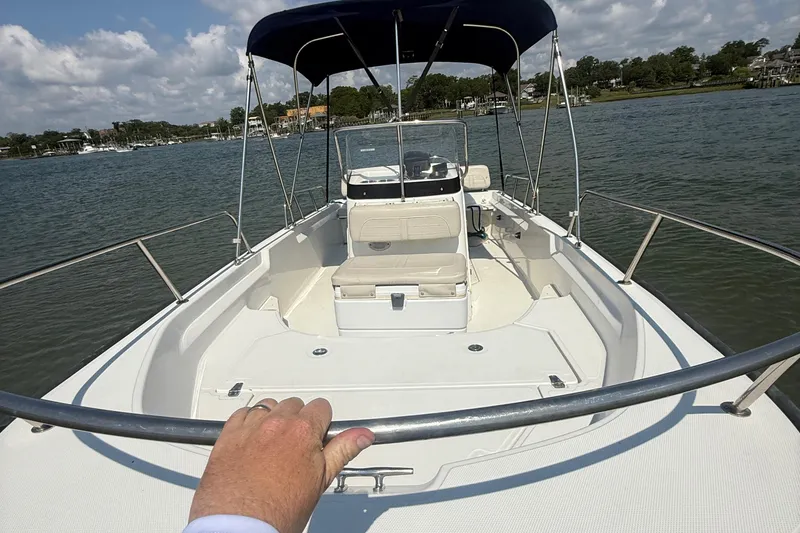Slide: The Image of 2022 Boston Whaler 170 Montauk boat on water, featuring spacious deck and canopy. - 14