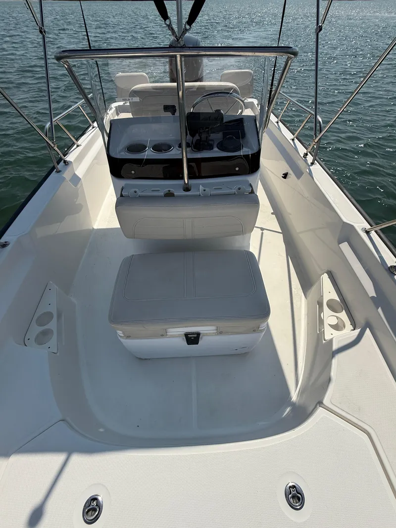 Slide: The Image of 2022 Boston Whaler 170 Montauk boat interior with seating and steering console. - 17