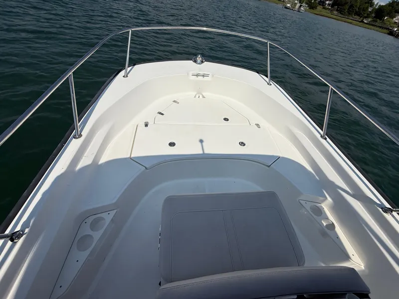 Slide: The Image of 2022 Boston Whaler 170 Montauk boat deck with seating, on calm water. - 25