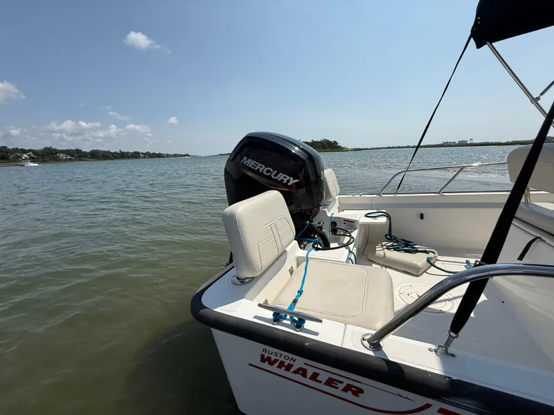 Slide: The Image of 2022 Boston Whaler 170 Montauk boat with Mercury engine on calm water. - 26