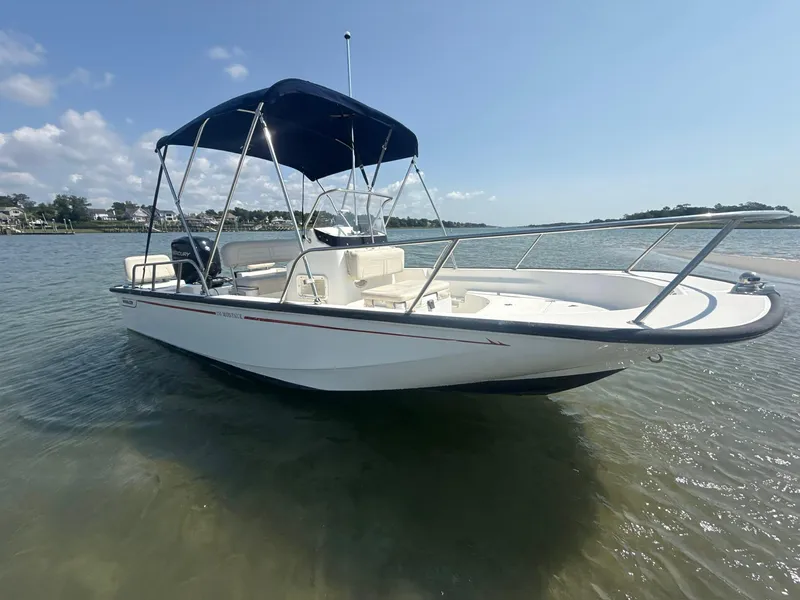 Slide: The Image of 2022 Boston Whaler 170 Montauk boat with canopy on calm water. - 3