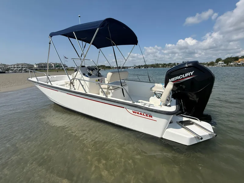 Slide: The Image of 2022 Boston Whaler 170 Montauk boat with Mercury engine on calm water. - 4