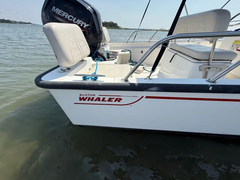 Slide: The Image of 2022 Boston Whaler 170 Montauk boat with Mercury engine on calm water. - 7