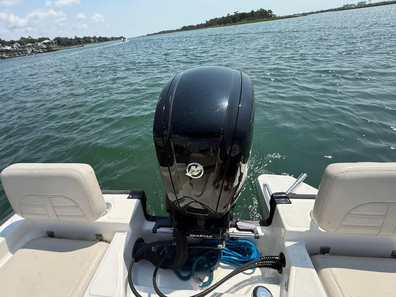 Slide: The Image of 2022 Boston Whaler 170 Montauk boat with outboard motor on calm water. - 9