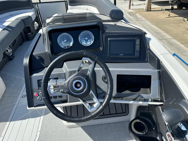 Slide: The Image of 2025 Avalon Catalina boat dashboard with steering wheel and control panel. - 17